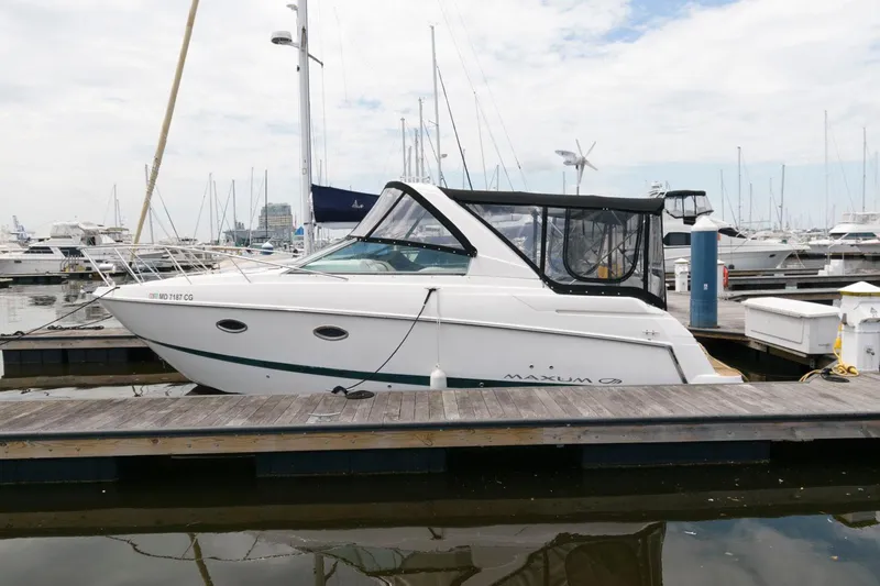 The Image of 2008 Maxum 2900 SE boat docked at marina, featuring sleek design and enclosed cabin. - 0