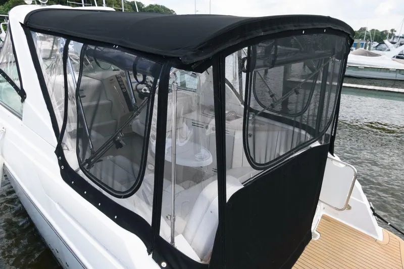 Slide: The Image of 2008 Maxum 2900 SE boat with black canopy and clear windows docked at marina. - 10