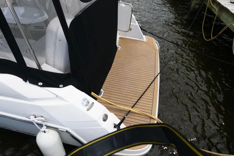 Slide: The Image of 2008 Maxum 2900 SE boat with teak swim platform, docked in water. - 11