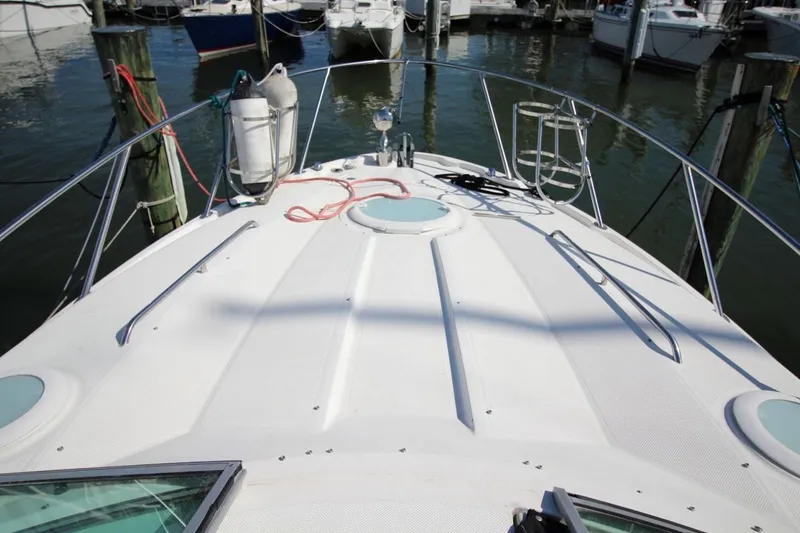 Slide: The Image of 2008 Maxum 2900 SE boat deck at marina, featuring railings and docked vessels. - 12