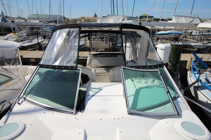 Slide: The Image of 2008 Maxum 2900 SE boat docked at marina with clear canopy and open windshield. - 13