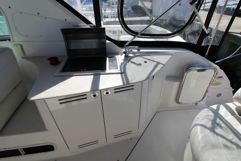 Slide: The Image of 2008 Maxum 2900 SE boat interior with kitchenette and seating area. - 16