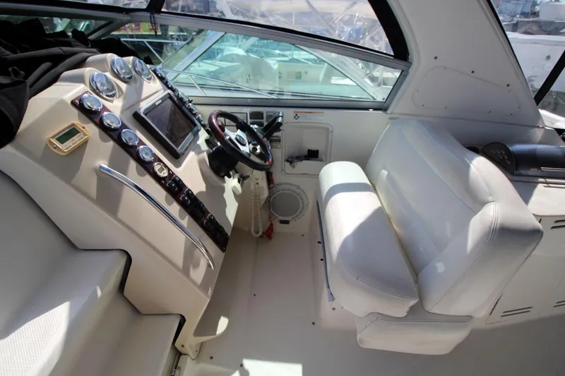 Slide: The Image of 2008 Maxum 2900 SE boat cockpit with steering wheel, gauges, and white seating. - 19