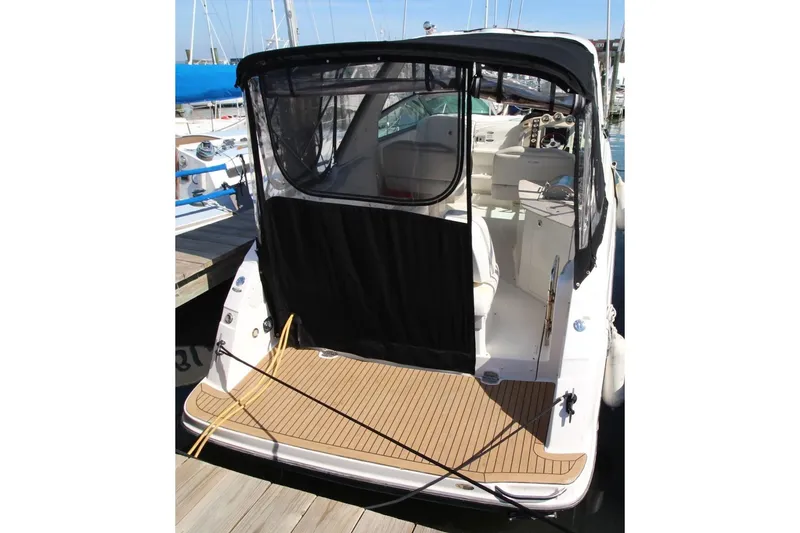 Slide: The Image of 2008 Maxum 2900 SE boat docked, featuring a covered cockpit and spacious deck area. - 4