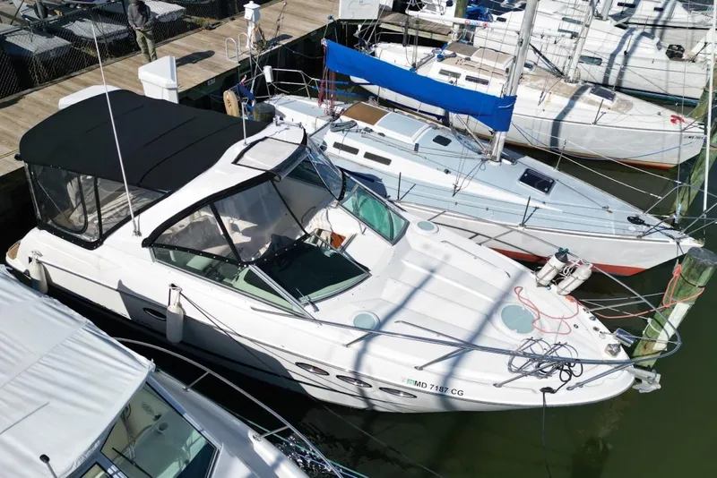 Slide: The Image of 2008 Maxum 2900 SE boat docked at marina, featuring sleek design and black canopy. - 6