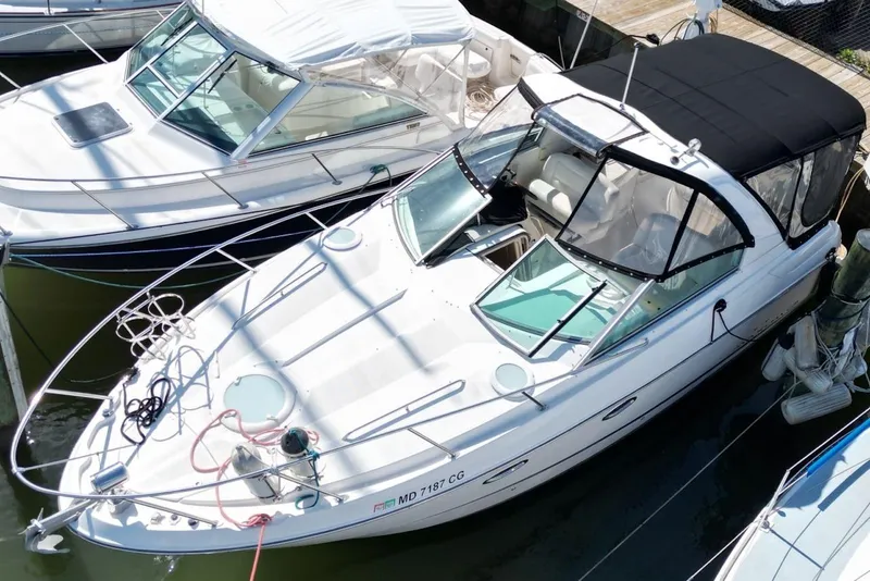 Slide: The Image of 2008 Maxum 2900 SE boat docked, featuring sleek design and black canopy. - 8