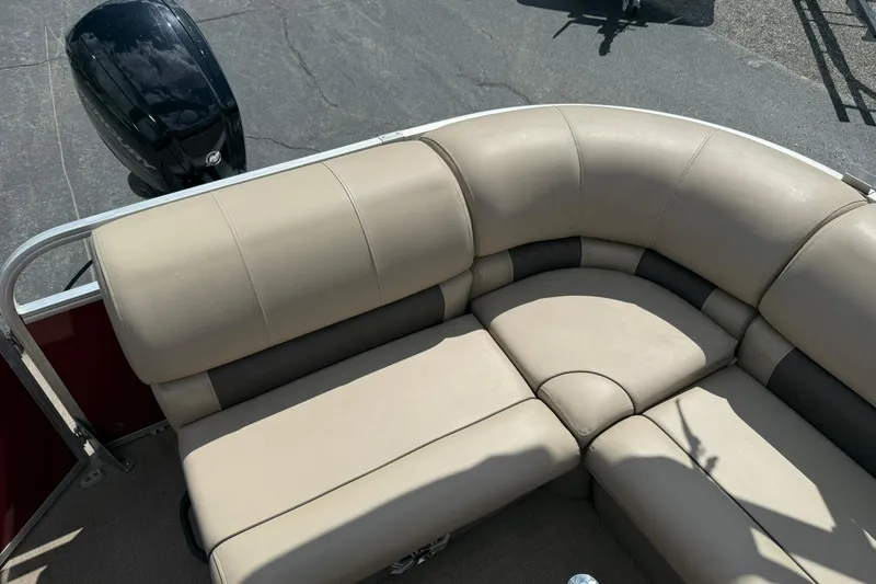 Slide: The Image of 2023 Sun Tracker Party Barge 20 DLX with beige seating and outboard motor. - 13