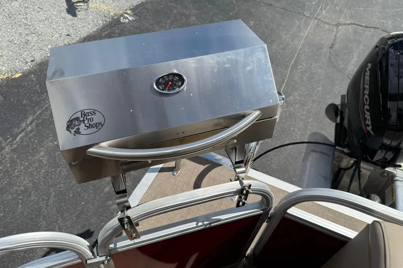 Slide: The Image of Bass Pro Shops grill on 2023 Sun Tracker Party Barge 20 DLX with Mercury engine. - 18