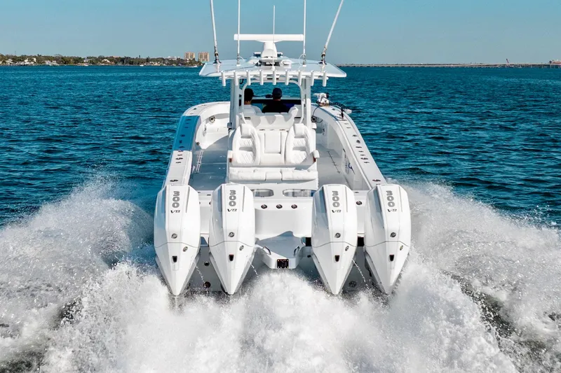Slide: The Image of 2026 Freeman 35 boat with four engines cruising on open water. - 10