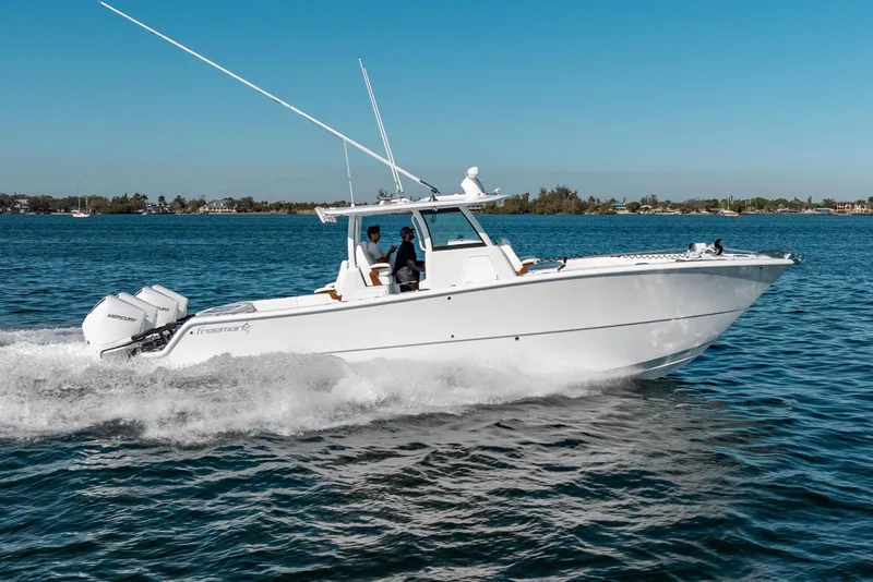 Slide: The Image of 2026 Freeman 35 boat cruising on clear blue water under a sunny sky. - 11