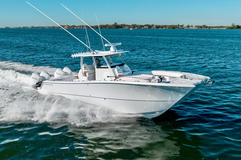 Slide: The Image of 2026 Freeman 35 boat cruising on open water under clear blue skies. - 12