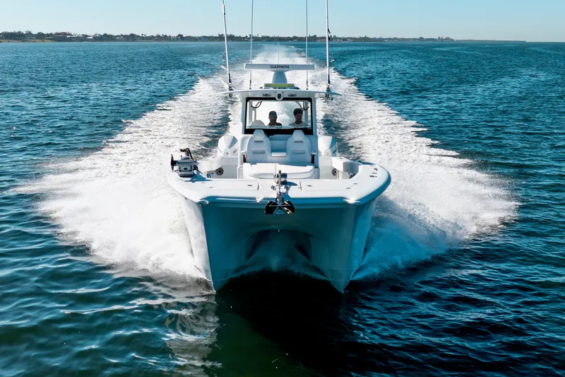Slide: The Image of 2026 Freeman 35 boat cruising on open water, creating a dynamic wake. - 14