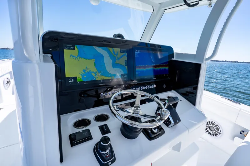 Slide: The Image of Freeman 35 boat dashboard with navigation screens and steering wheel, 2026 model. - 16