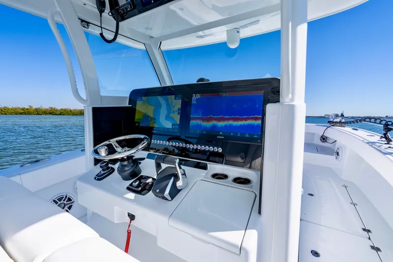 Slide: The Image of Modern Freeman 35 boat cockpit with advanced navigation screens, steering wheel, and controls, 2026 model. - 17