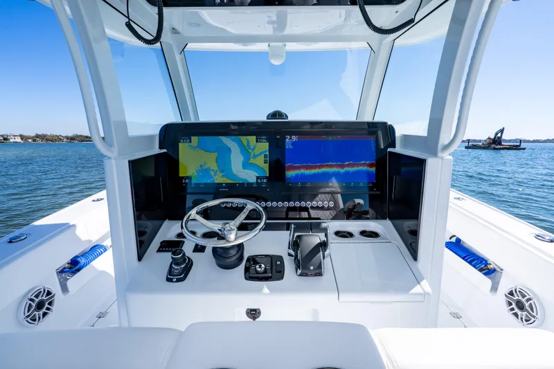 Slide: The Image of Helm of 2026 Freeman 35 boat with advanced navigation displays on open water. - 19