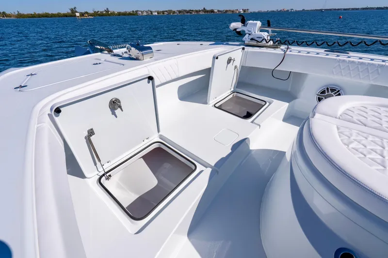 Slide: The Image of 2026 Freeman 35 boat deck with open storage compartments on a sunny day. - 22