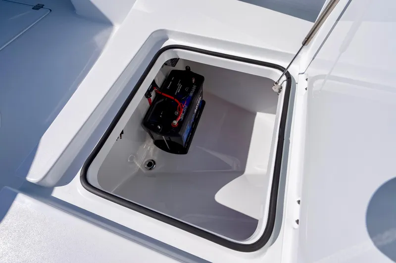 Slide: The Image of Open battery compartment on a 2026 Freeman 35 boat, showcasing interior storage. - 23