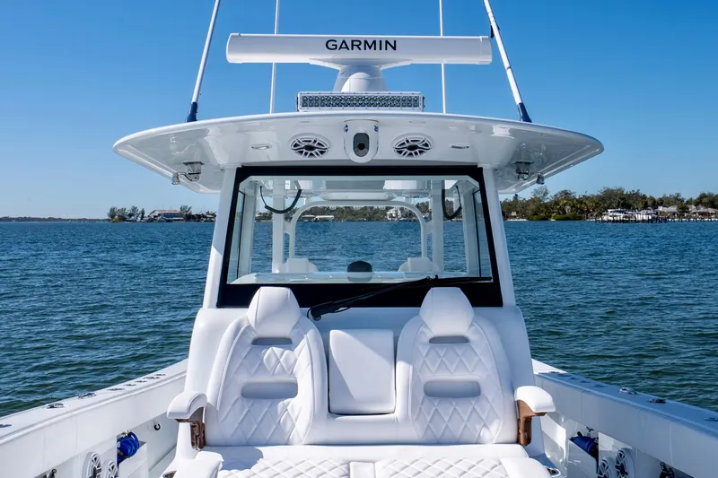 Slide: The Image of Luxury Freeman 35 boat interior, 2026 model, on calm blue waters under clear sky. - 29