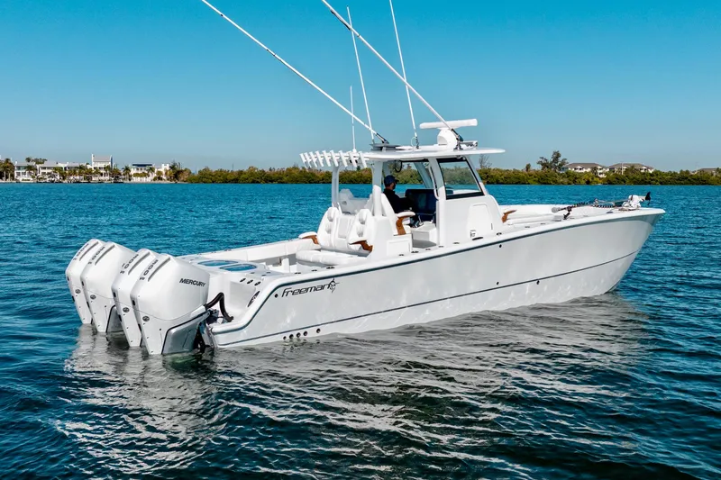 Slide: The Image of 2026 Freeman 35 boat with triple Mercury engines on calm water. - 3