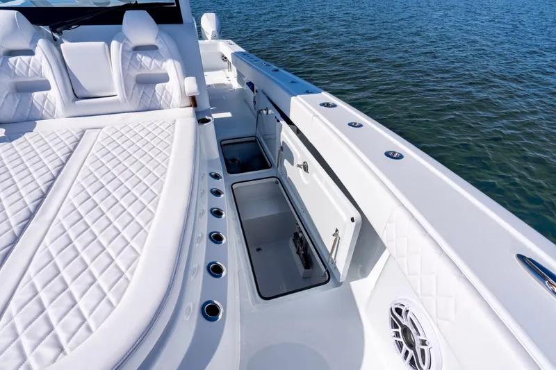 Slide: The Image of Luxurious 2026 Freeman 35 boat interior with white quilted seating and storage compartments. - 31