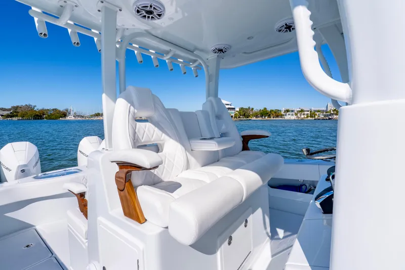 Slide: The Image of Luxurious seating on a 2026 Freeman 35 boat, featuring white upholstery and wooden accents. - 33
