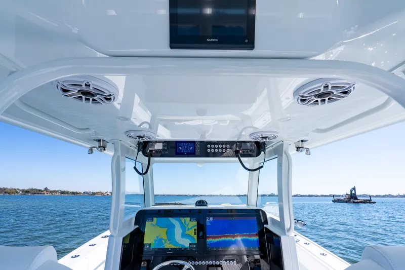 Slide: The Image of 2026 Freeman 35 boat cockpit with advanced navigation systems on a clear day. - 35