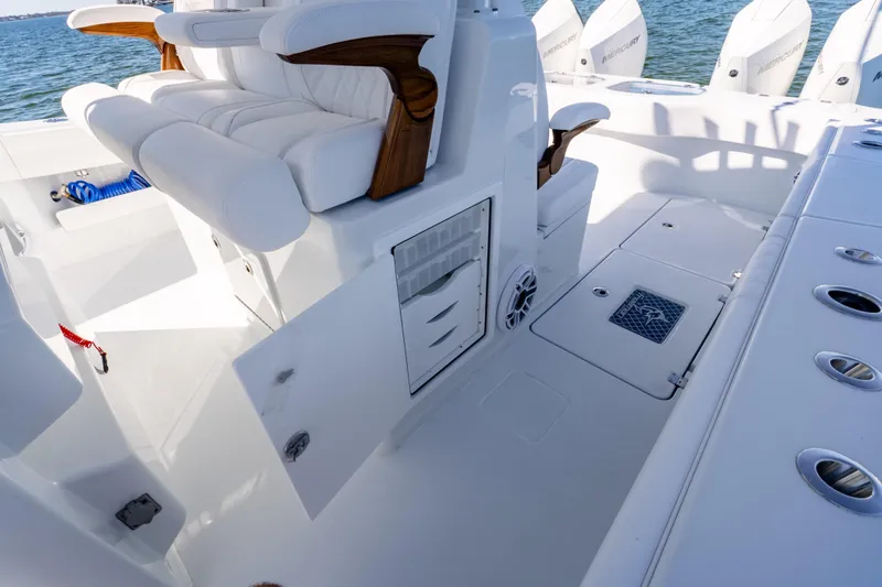 Slide: The Image of Luxurious interior of 2026 Freeman 35 boat with white seating and storage compartments. - 37