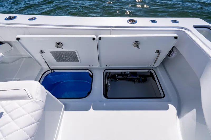 Slide: The Image of Open storage compartments on a 2026 Freeman 35 boat, with ocean in the background. - 42