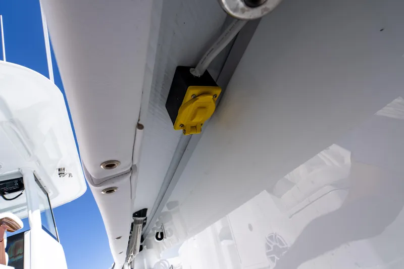 Slide: The Image of Yellow electrical outlet on Freeman 35 boat, 2026 model, under bright blue sky. - 46