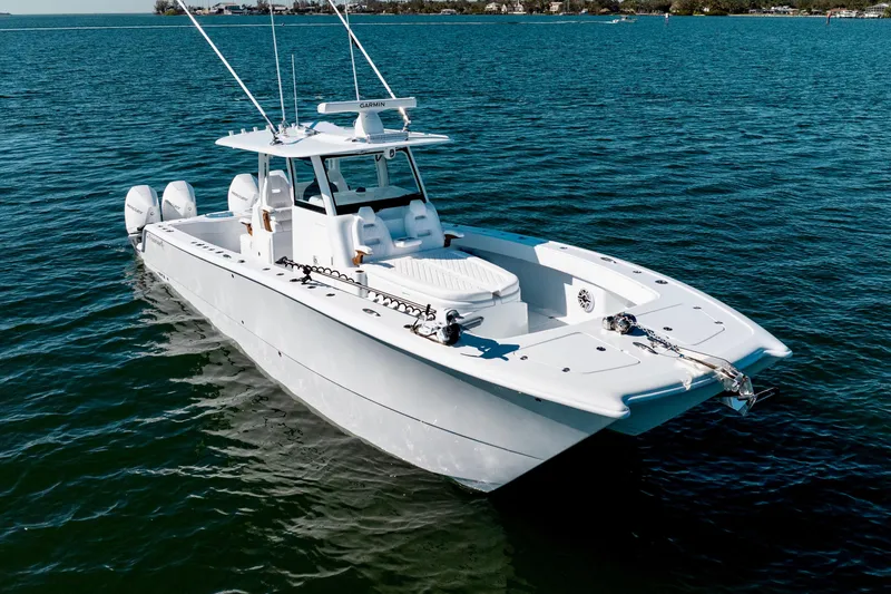 Slide: The Image of 2026 Freeman 35 boat on calm blue water, featuring twin engines and sleek design. - 5