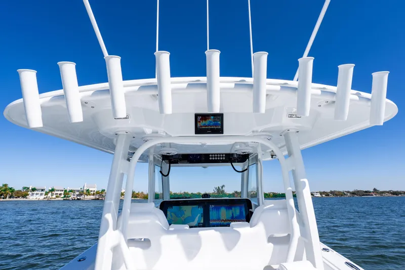 Slide: The Image of 2026 Freeman 35 boat helm with advanced navigation screens and rod holders on a sunny day. - 50