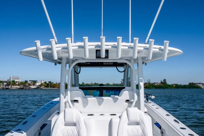 Slide: The Image of 2026 Freeman 35 boat on water, featuring sleek design and rod holders. - 52