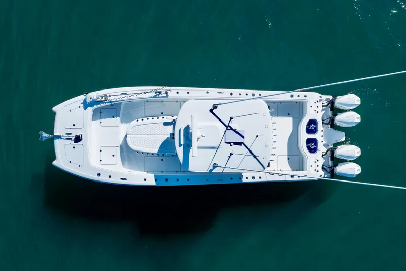 Slide: The Image of Aerial view of 2026 Freeman 35 boat with triple engines on clear water. - 7