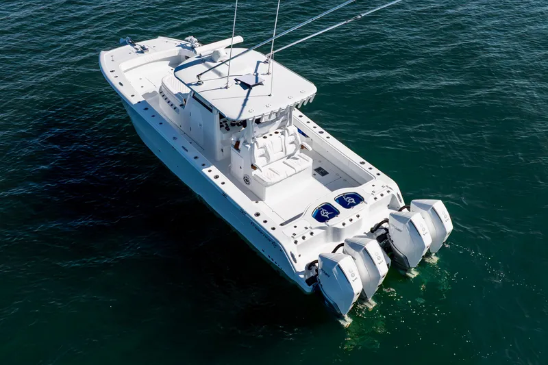 Slide: The Image of 2026 Freeman 35 boat with triple outboard engines on open water. - 8