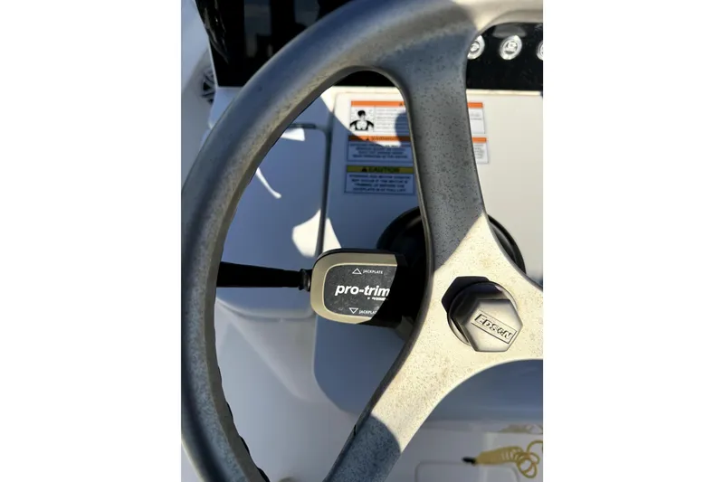 Slide: The Image of Steering wheel of 2024 Contender 25 Bay boat with pro-trim control. - 16
