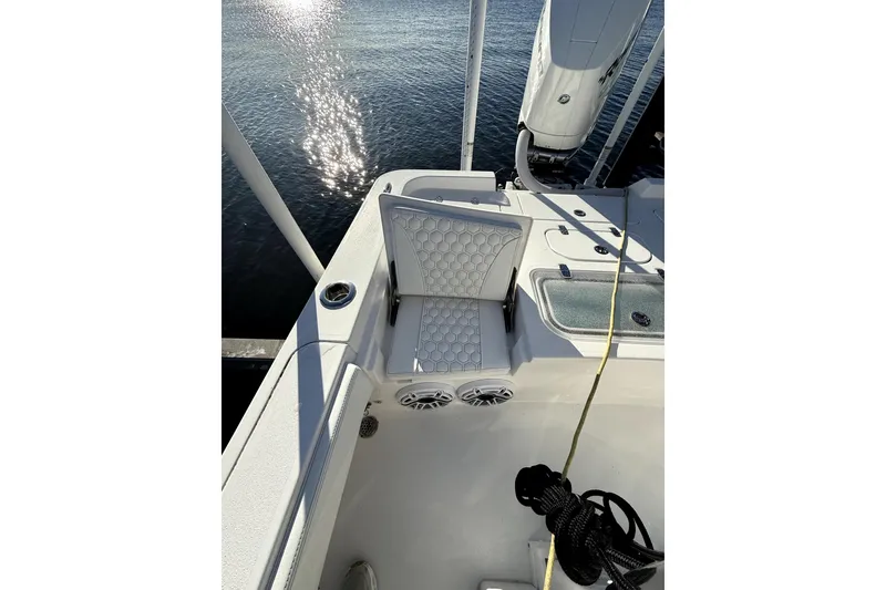 Slide: The Image of 2024 Contender 25 Bay boat interior with cushioned seating and water reflection. - 17