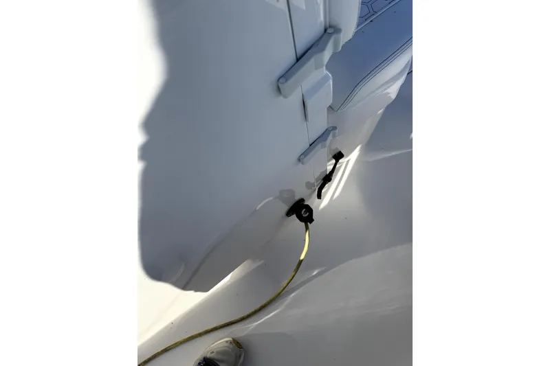 Slide: The Image of 2024 Contender 25 Bay boat interior with rope and latch detail. - 24