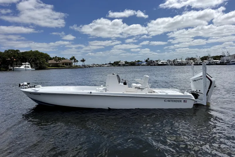 Slide: The Image of 2024 Contender 26 Bay boat on calm water under a partly cloudy sky. - 3