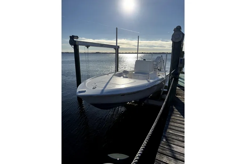 Slide: The Image of 2024 Contender 25 Bay boat docked at sunset on calm waters. - 6