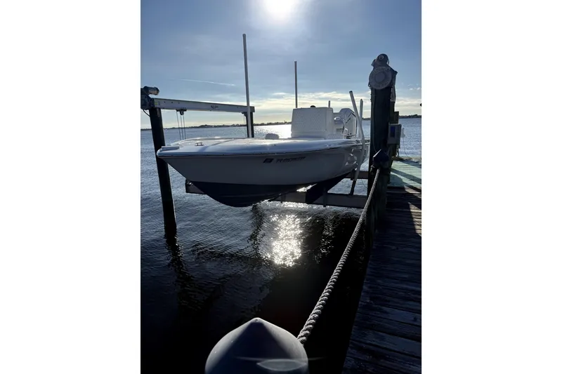 Slide: The Image of 2024 Contender 25 Bay boat docked on a sunny day by the water. - 8