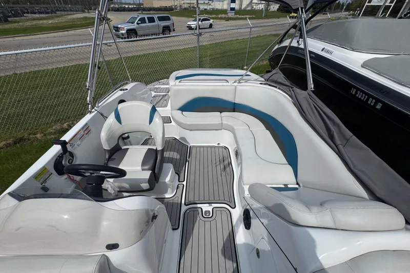 Slide: The Image of 2019 Hurricane SunDeck Sport 202 IO boat interior with seating and steering wheel. - 14