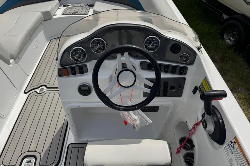 Slide: The Image of 2019 Hurricane SunDeck Sport 202 IO boat dashboard with steering wheel and controls. - 16