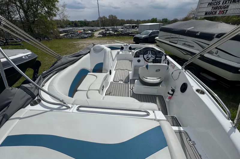 Slide: The Image of 2019 Hurricane SunDeck Sport 202 IO boat interior with seating and steering wheel. - 27