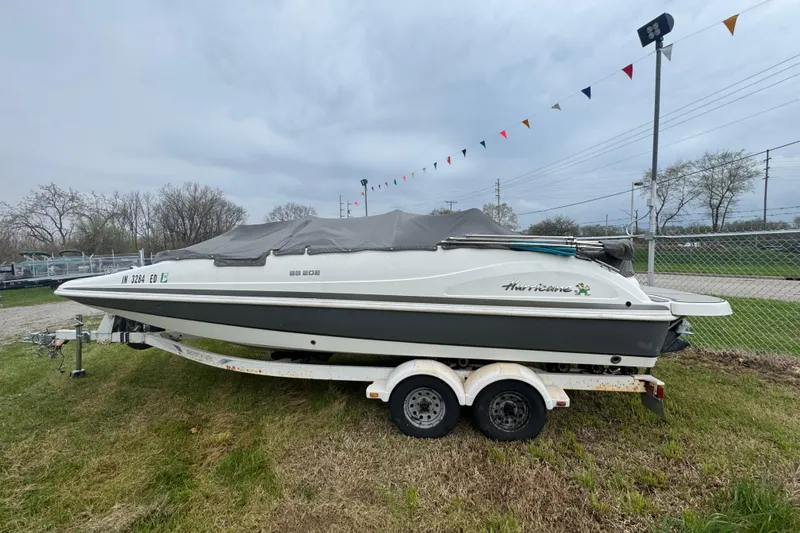 Slide: The Image of 2019 Hurricane SunDeck Sport 202 IO boat on trailer, covered, outdoors. - 4