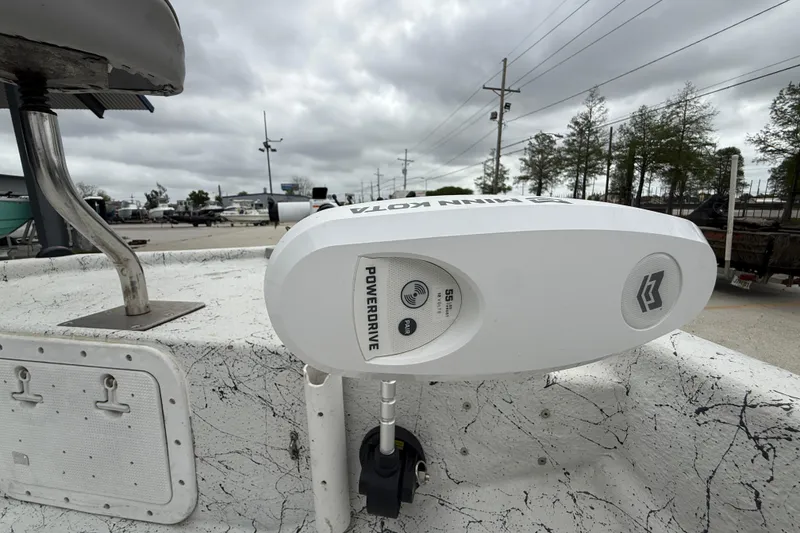 Slide: The Image of 1991 Avenger 210 Bay Runner with Minn Kota PowerDrive motor, outdoor setting. - 10