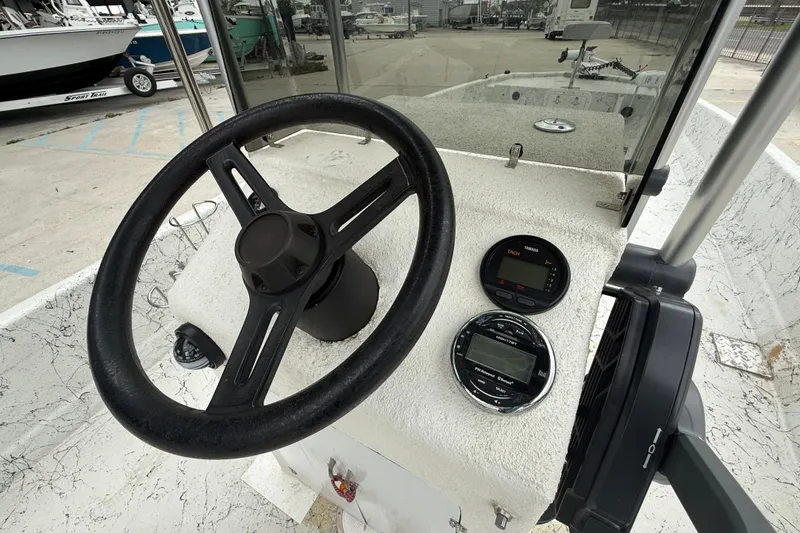 Slide: The Image of Steering console of a 1991 Avenger 210 Bay Runner boat with gauges and controls. - 13