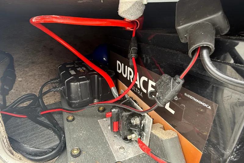 Slide: The Image of Battery setup in a 1991 Avenger 210 Bay Runner boat with red wiring connections. - 15