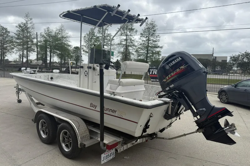 Slide: The Image of 1991 Avenger 210 Bay Runner boat with Yamaha outboard motor on trailer. - 4