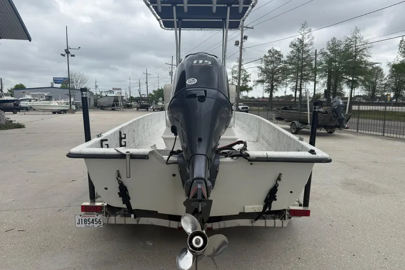 Slide: The Image of 1991 Avenger 210 Bay Runner boat with outboard motor, parked on a trailer. - 5