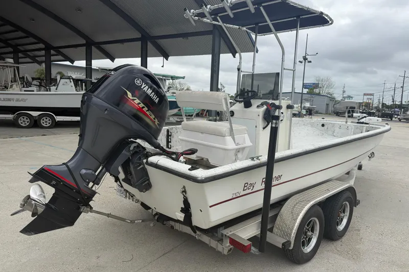 Slide: The Image of 1991 Avenger 210 Bay Runner boat with Yamaha outboard motor on trailer. - 6